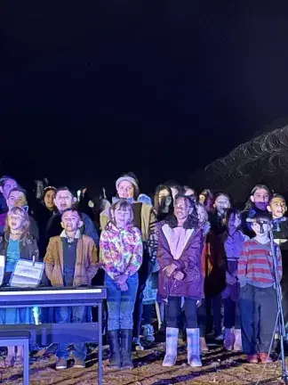 Children sing a concert at the US-Mexico border wall